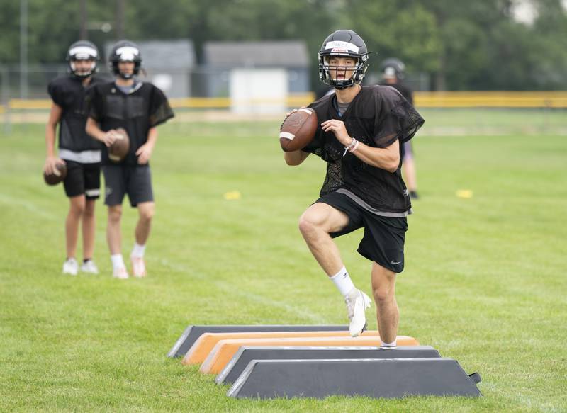 Crystal Lake Central quarterback Jason Penza runs a drill during practice for the Crystal Lake Central varsity football team on Wednesday, July 21 at Crystal Lake Central High School in Crystal Lake.