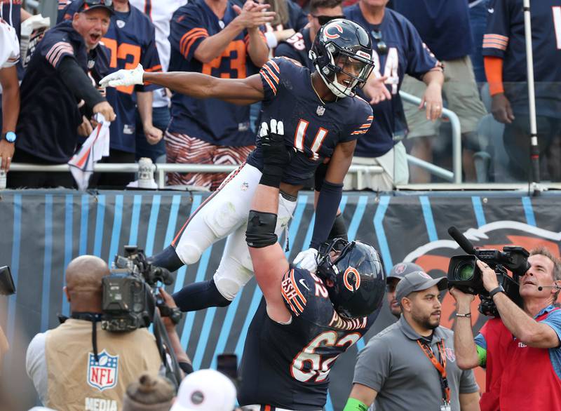 Chicago Bears guard Lucas Patrick hoists Chicago Bears wide receiver Darnell Mooney after he caught a touchdown in the second half of their game against the Green Bay Packers Sunday, Sept. 10, 2023, at Soldier Field in Chicago.