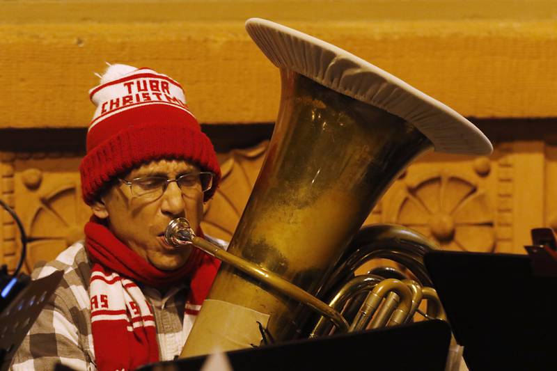 Brian Allan plays the tuba during the Lighting of the Square on Friday, Nov. 25, 2022, in Woodstock. The annual event featured brass music, caroling, free doughnuts and cider, food trucks, festive selfie stations and shopping.