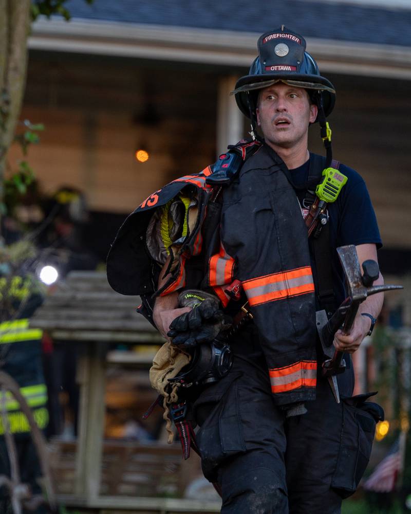 Firefighter walks towards the road on Saturday, July 19, 2025, in the 1400 Block of U.S. Route 6 in Ottawa.