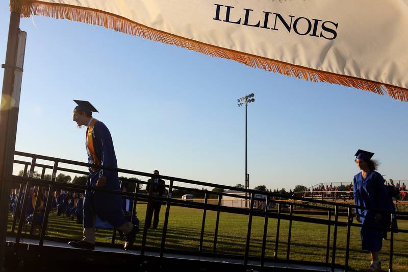Johnsburg graduates head up to the podium for their diplomas during their graduation at Johnsburg High School on Friday, June 4, 2021 in Johnsburg.