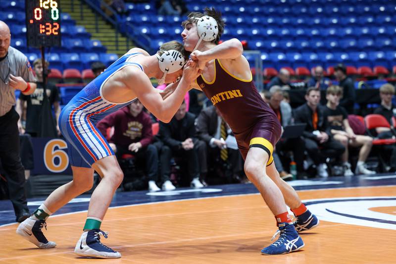Montini's Bobby Ruscitti, right, grabs ahold of Marmion Academy's Adian McClure in the 126-pound match during Marmion Academy's victory over Montini in the IHSA Class 3A Dual Team State championship on Saturday, Feb. 28, 2026.