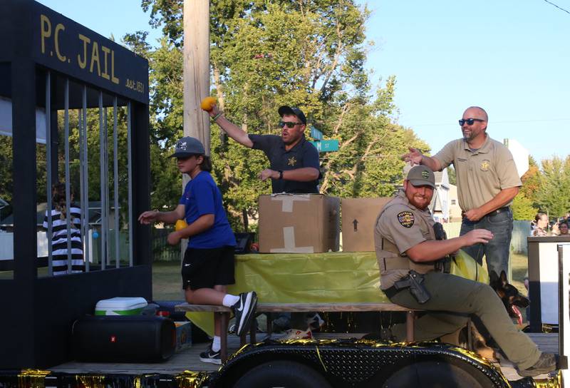 Putnam County Sheriff Josh Boedigheimer (far right) throws footballs to the crowd with other deputies during the inaugural Homecoming parade on Wednesday, Sept. 17, 2025 down Elm Street in Granville.