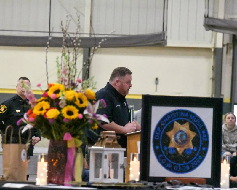 Mike McTighe, vice president of Illinois Concerns of Police Survivors, speaks during a memorial vigil to mark one year since the late sheriff's deputy Christina Musil, 35, was killed in the line of duty in a rear-end car crash in Waterman while on patrol on March 28, 2024. The vigil was held at the Sycamore High School Field House on Saturday, March 29, 2025.