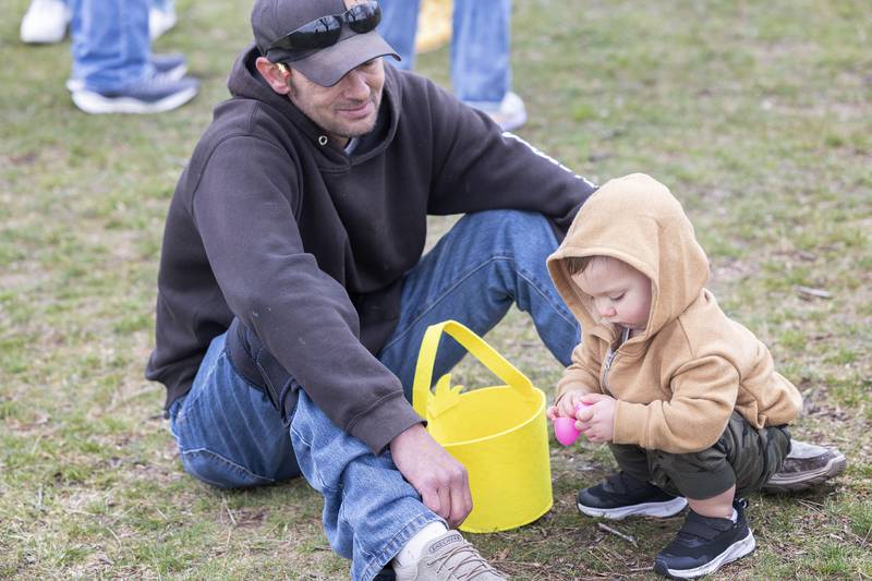 Chris Rasmussen with son Ash, 1, of Grand Detour counts up their eggs Saturday, March 30, 2024 in Polo.