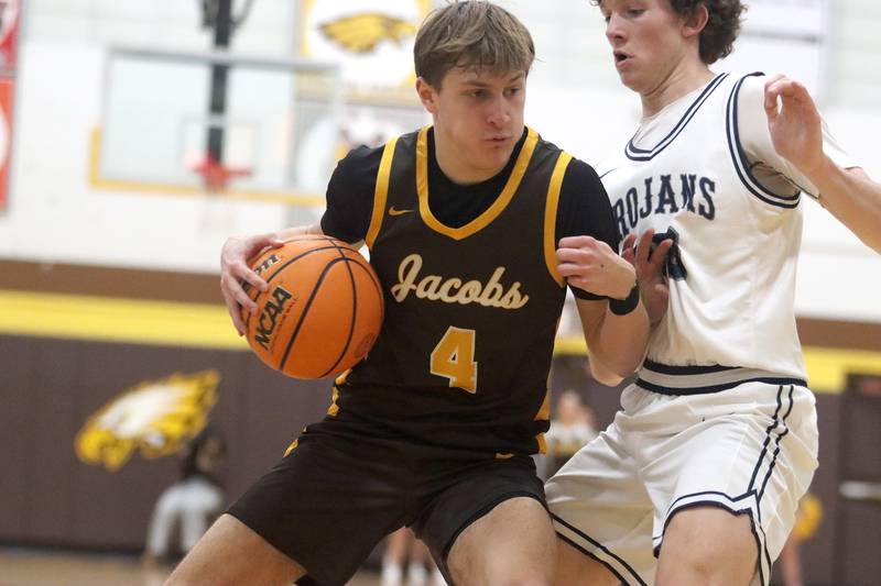 Jacobs’ Nolan Roper, left, moves the ball against Cary-Grove’s Ryan Boutwell during Hinkle Holiday Classic varsity boys basketball tournament action on Thursday, Dec. 26, 2024 at Jacobs High School in Algonquin.
