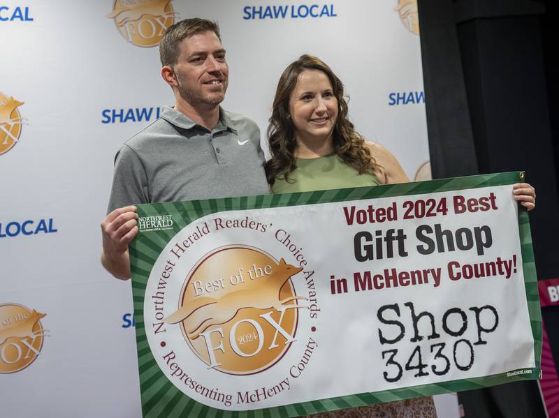 Business owners David and Danielle Badgley pose for a photo with their award banner for their gift shop Shop 3430 in McHenry during the Northwest Herald Best of the Fox awards ceremony on Thursday, September 19, 2024 at Lou's Lounge at the Dole Mansion in Crystal Lake. Ryan Rayburn for Shaw Local