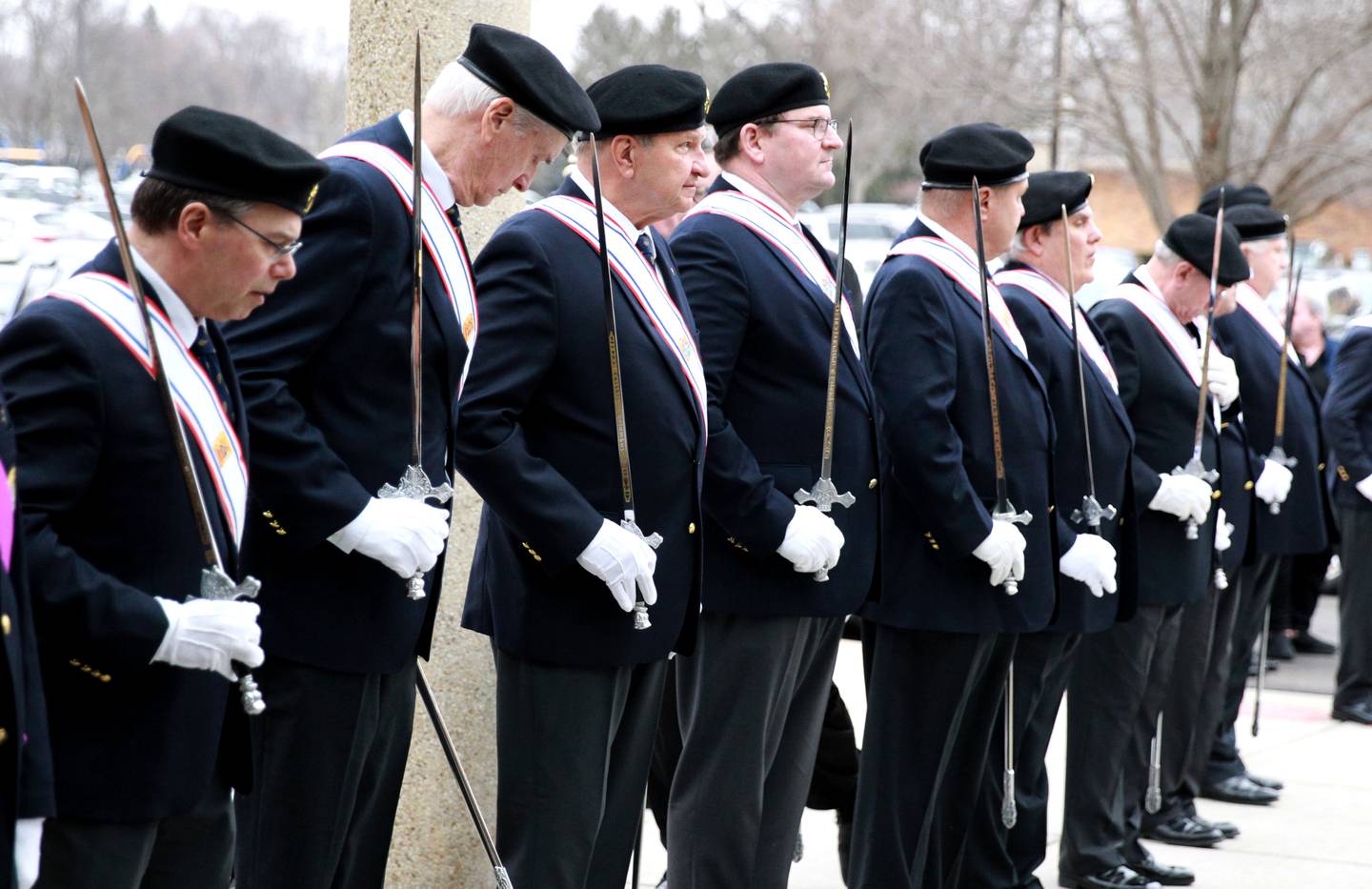 Members of the Knights of Columbus line up outside St. Peter Catholic Church in Geneva before the Mass of Christian Burial for Reverend Jonhathan Bakkelund on Wednesday, Jan. 31, 2024.