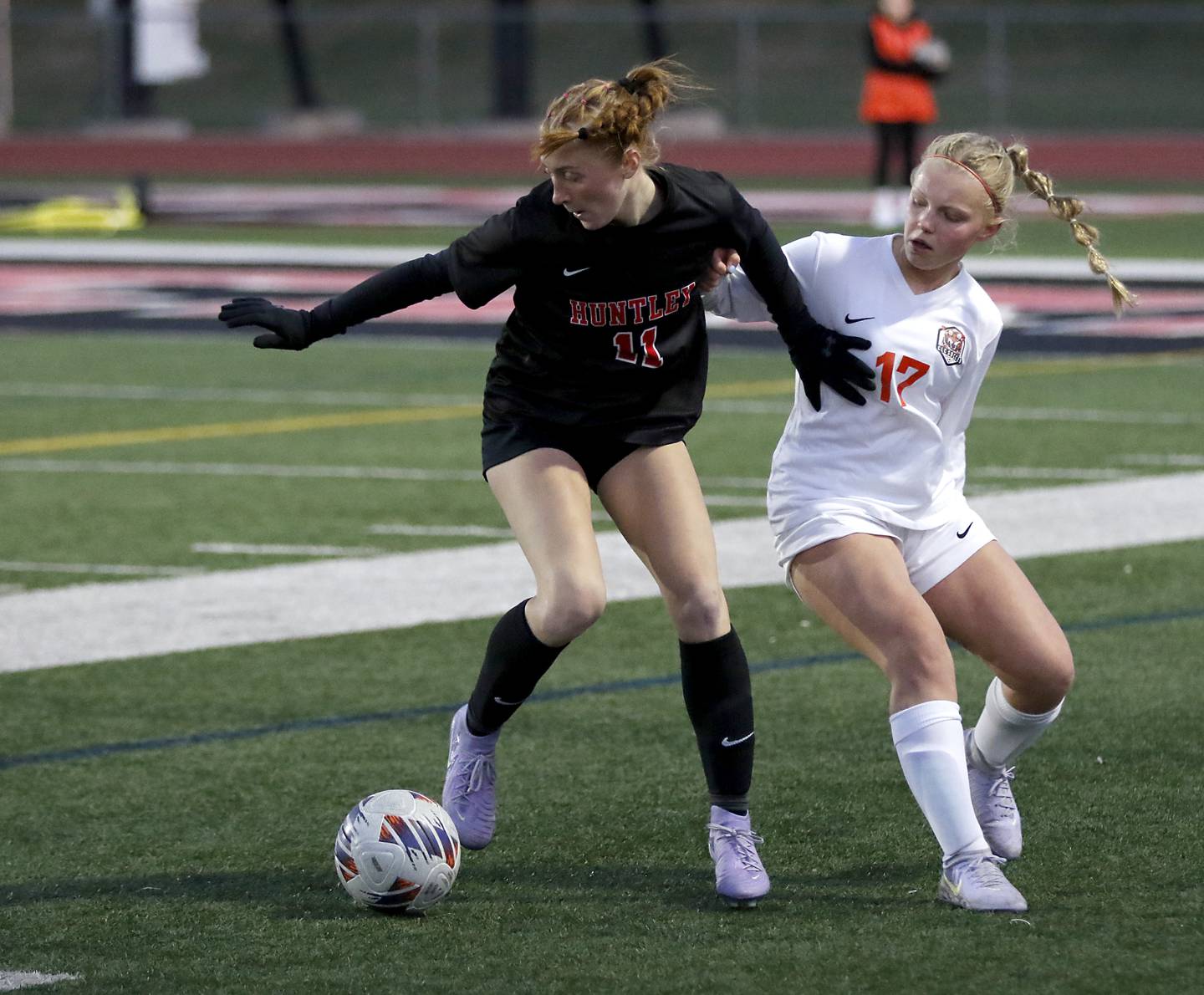 Huntley's Maddie Rumachik tris to spin out of the defense of Crystal Lake Central's Mia Murphy during a Fox Valley Conference  soccer match on Tuesday, April 15, 2025, at Huntley High School.