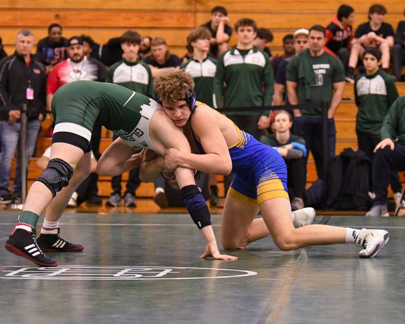 Gunnar Garelli of Lyons Township, right, grabs ahold of Glenbard West wrestler Collin Carrigan during the regional title match on Saturday Feb. 3, 2024 held at Glenbard West High School where Gunnar took the win.