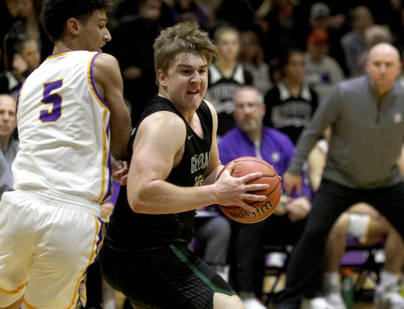 Glenbard West’s Jack Oberhofer (right) turns toward the basket during a game at Downers Grove North on Friday, Jan. 13, 2023.