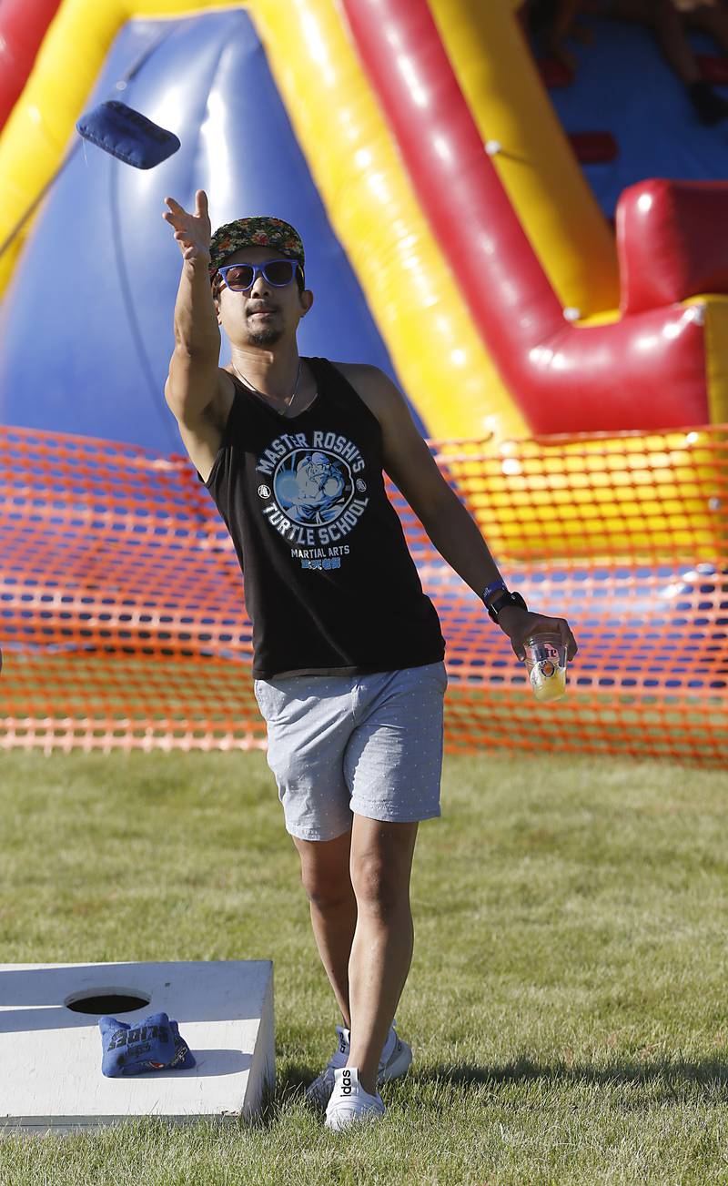 Fredel Salarda, of Algonquin, tosses a bag as he warms up for the Algonquin Founders’ Days Festival Bags Tournament Friday, July 29, 2022, at Ted Spella Community Park, 2610 Harnish Drive, in Algonquin. This year marks the festival’s 60th anniversary that includes over 40 events, including live music, food and drinks, a carnival, and market bazaar. The festival runs from 2 to 11 p.m. July 30 and 10 a.m. to 9 p.m. July 31. A Founders’ Day Christmas in July Parade will run through Main Street in downtown Algonquin beginning at 11 a.m. July 30.