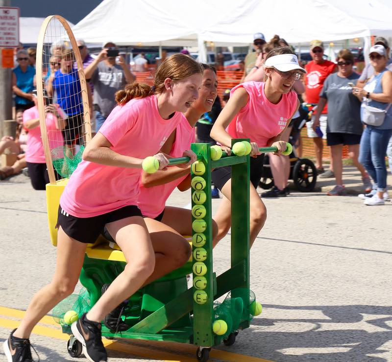 Team Long Deuce (l-r) Anna Bishop, Kassidi Catanag and Marisa Urban participate in the Toilet Bowl Races at the Maple Park Fun Fest on Saturday, Sep. 3, 2022.