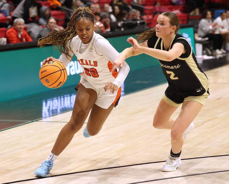 DeKalb's Zora Watts drives by Sycamore's Sydney Fabrizius Friday, Jan. 30, 2026, during their game in the FNBO Challenge in the Convocation Center at Northern Illinois University in DeKalb.