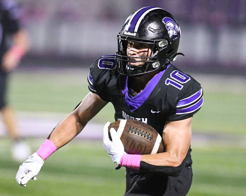 Downers Grove North's Oliver Thulin (10) runs the ball during the game on Friday Oct. 10, 2025, while taking on York High School held at Downers Grove North High School.