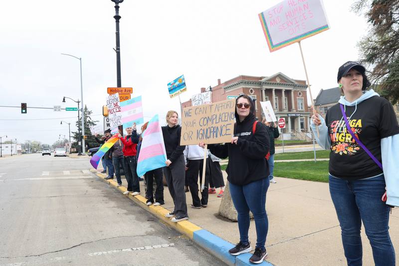 Protesters hold signs and flags alongside over 250 fellow demonstrators during the Hands Off Rally at the Kankakee County Courthouse on Saturday, April 19, 2025.