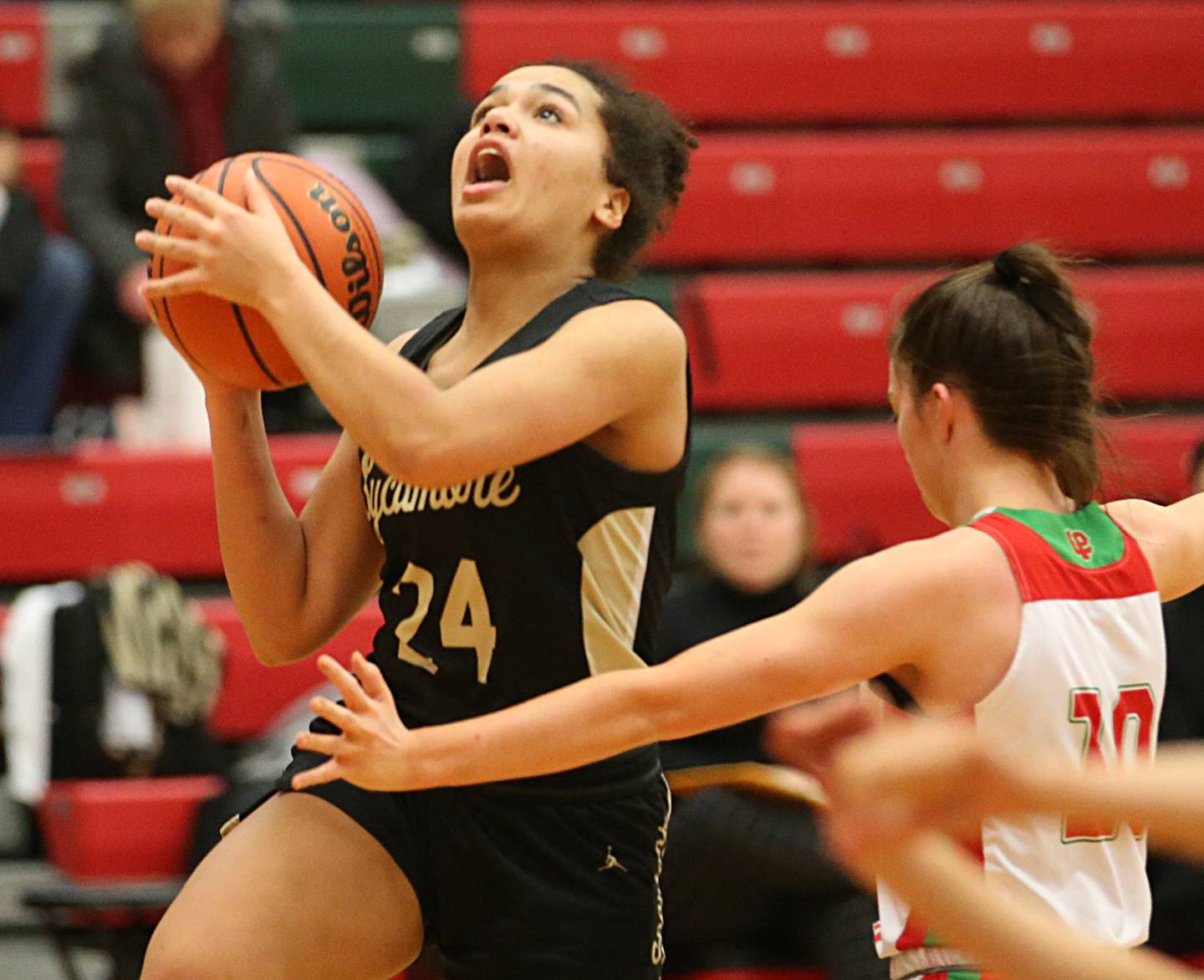 Sycamore's Monroe McGhee drives to the basket as L-P's Bailey Pode defends on Tuesday, Jan. 31, 2023 at L-P High School.