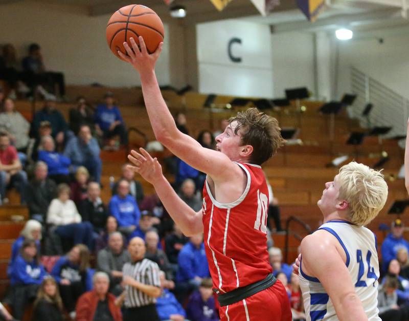 Ottawa's Evan Snook eyes the hoop as he moves around Princeton's Daniel Sousa on Monday, Feb. 5, 2024 at Prouty Gym.