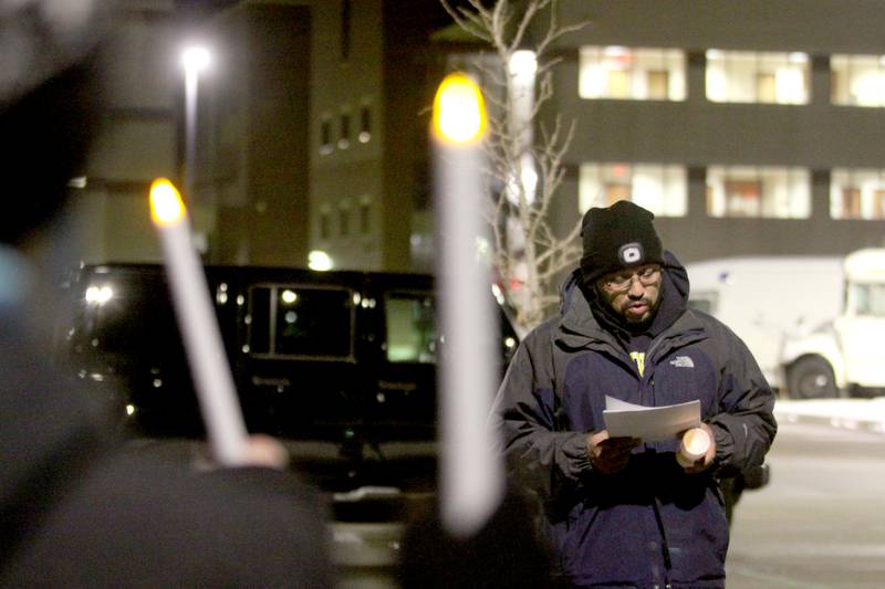 Activists held a candlelight march to the front of the McHenry County Correctional Facility the evening of Wednesday, Dec. 29, 2021, using a bullhorn to offer encouraging words to inmates and detainees. Former detainee Cesar Elizarraraz spoke to those gathered as part of the event arranged by the Coalition to Cancel the ICE Contract in McHenry County.