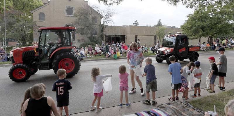 Children line up to get candy during the Elburn Days parade Friday August 19, 2022 in Elburn.