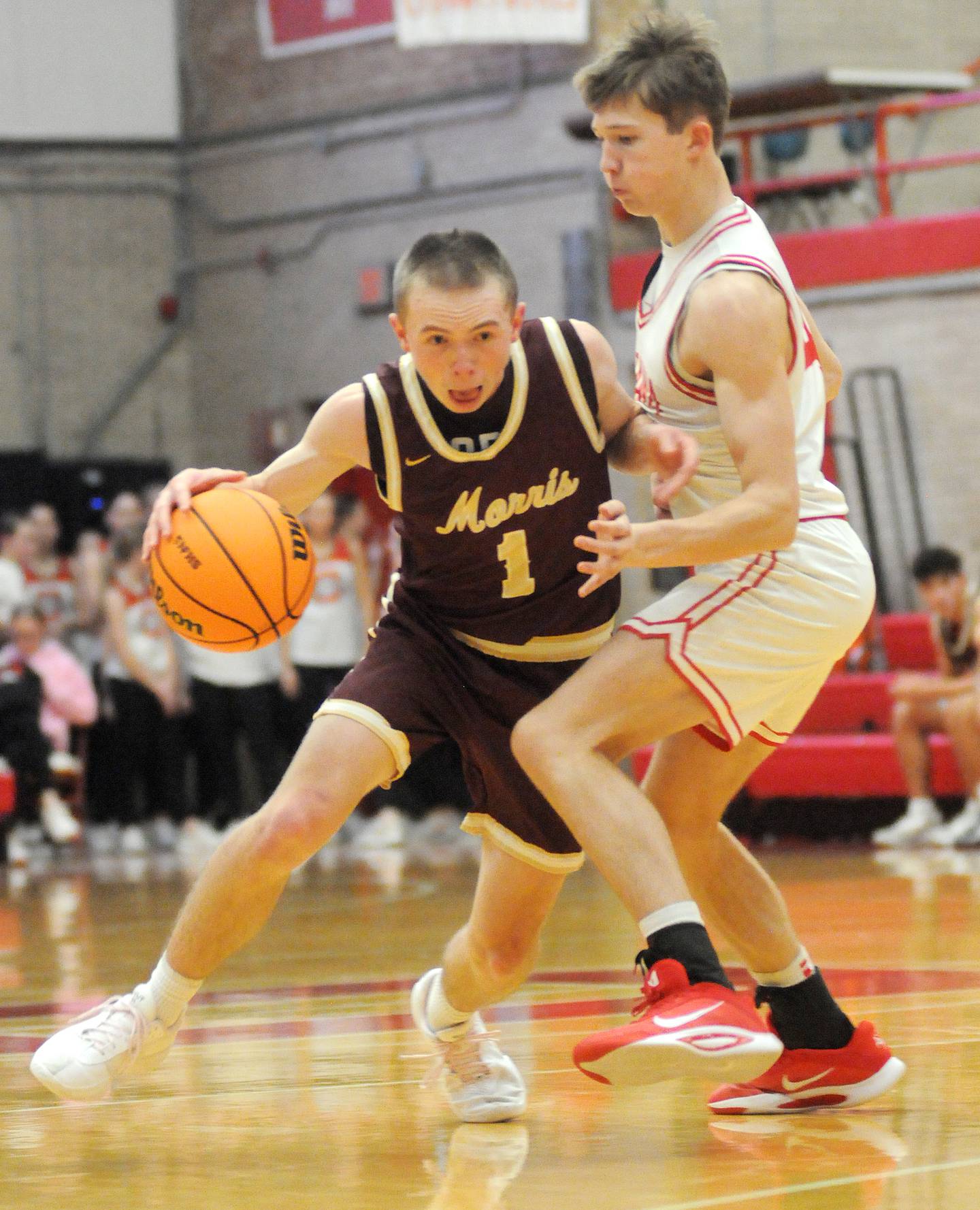 Morris senior Landon Norris (1) dribbles past Ottawa sophomore Blake Schiltz on Friday, Dec. 12, 2025 at Kingman Gym.