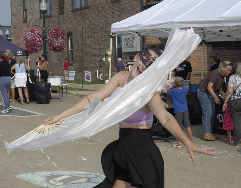 Performer  Jordan Reinwald  dances at Venetian Night. Venetian Night in Dixon featured magicians, street performers, face painting, a spaghetti eating contest, mini boat races,  a Drone light show and more. The Discover Dixon event was held along the riverfront in Dixon on August 9, 2025.