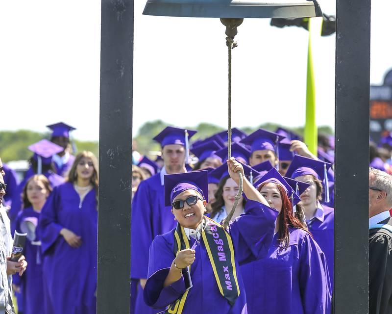 Graduates ring the bell before leaving the field after the Plano High School Graduation ceremony Sunday, May 18, 2025 in Plano.