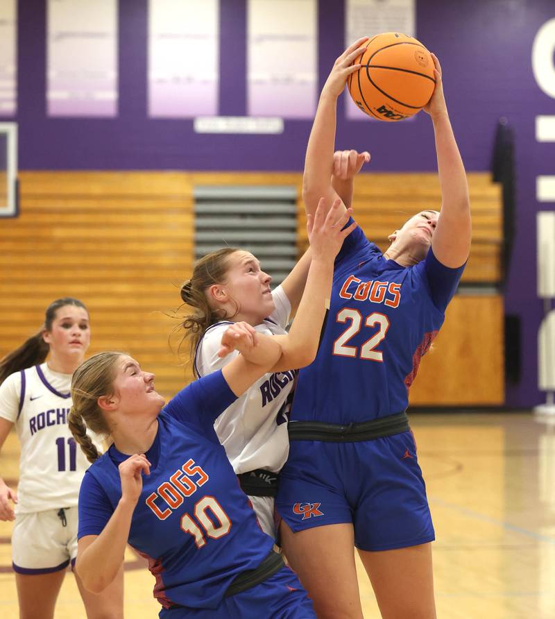 Genoa-Kingston's Arielle Rich (left) Rochelle's Reese Kissack and Genoa-Kingston's Regan Creadon (right) go after a rebound during their game Monday, Dec. 15, 2025, at Rochelle High School.