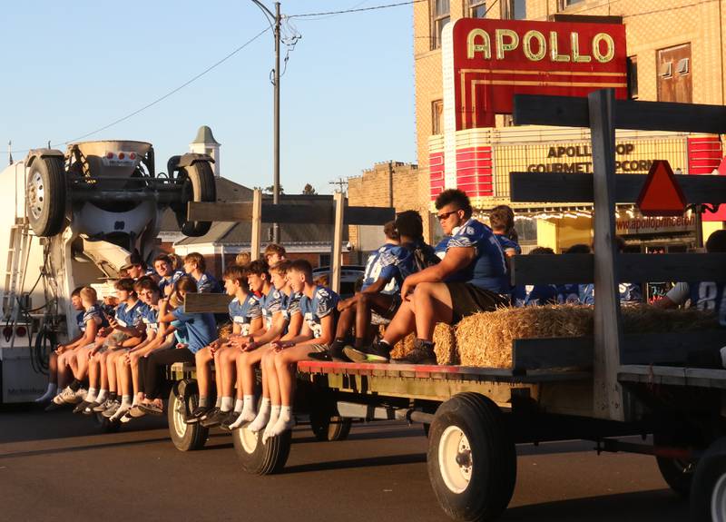 The Princeton High School football team rides past the Apollo Theater during the homecoming parade on Thursday, Sept. 25, 2025 along South Main Street in Princeton .