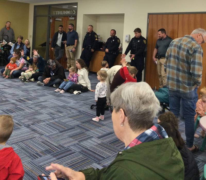 Ottawa police officers and firefighters joined children during Shake! Rattle! and Read! on Wednesday, April 10, 2024, at Reddick Library in Ottawa to celebrate National Library Week.