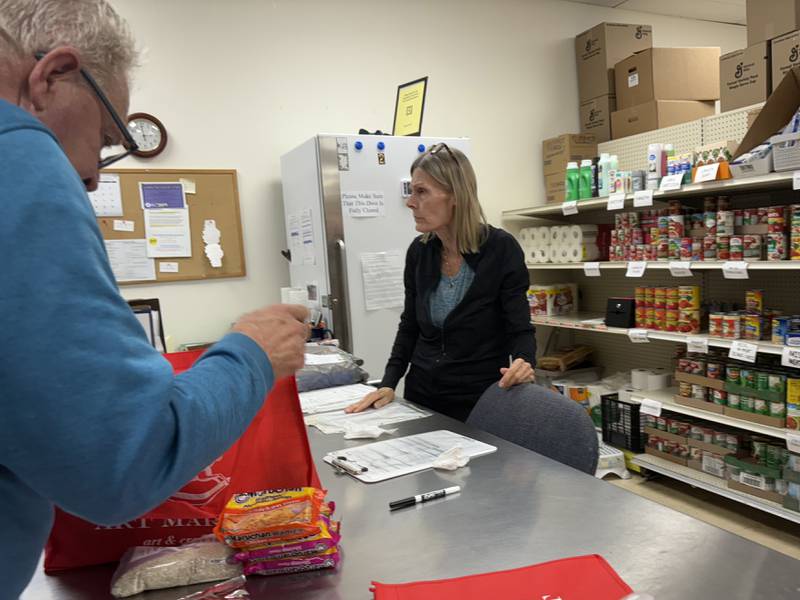 Woodstock Food Pantry board president Bruce Thacker, left, packs food at the pantry Oct. 31, 2025.