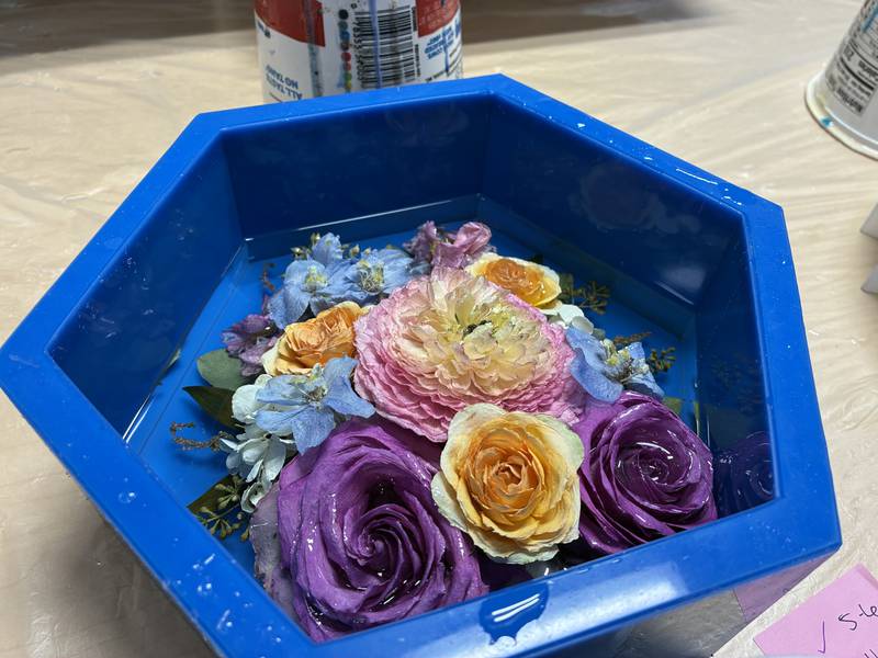 Dried flowers from a wedding arrangement at Bupp Woodworks & Designs on Nov. 28, 2025. The McHenry-based business encase the flowers in resin to preserve them.