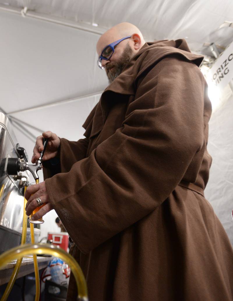Steve Newman of Brother Chimp Brewing in North Aurora pours beer for participants of the Westmont Winter Beer Festival  Saturday Feb 18, 2023.