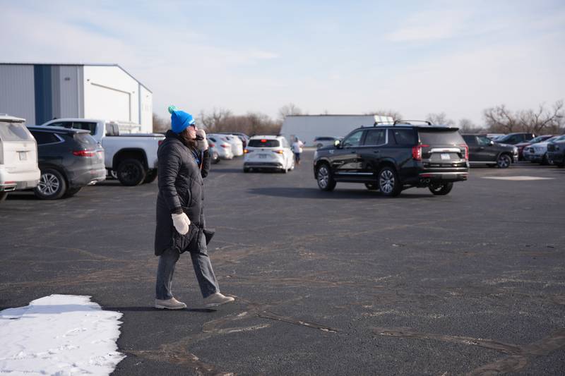 Volunteer Stephanie Dorsz of Addison directs the flow of Penguin Plunge attendees as they arrive at the 2025 Penguin Plunge on Saturday, Jan. 25th at skydive Chicago in Ottawa.