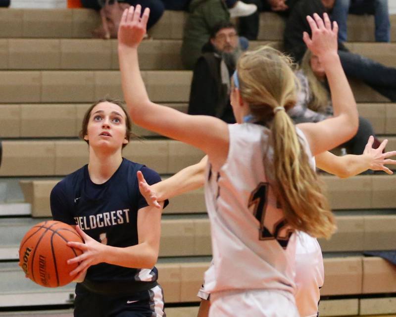 Fieldcrest's Kaitlin White (1) looks to shoot the ball as Marquette's Lilly Craig (12) defends in the Integrated Seed Lady Falcon Basketball Classic on Thursday, Nov. 17, 2022 in Flanagan.