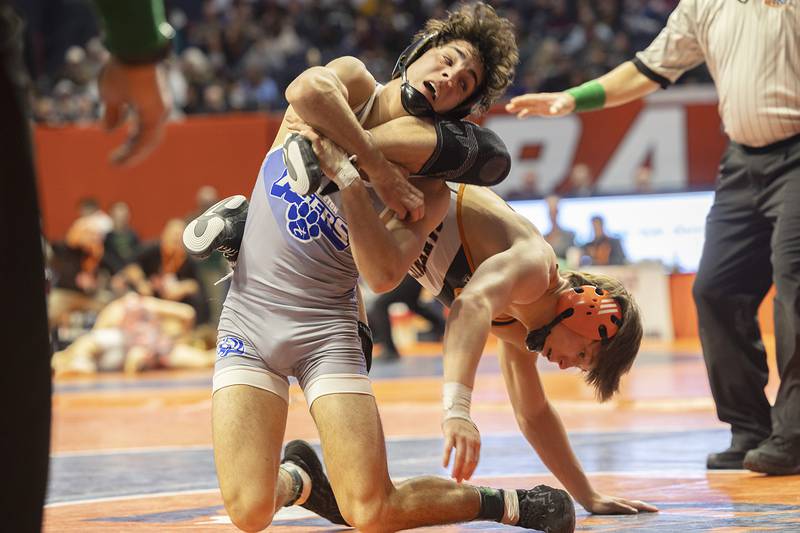 Princeton’s Ace Christiansen flips Sandwich’s Cooper Corder in the 138 pound 1A third place match Saturday, Feb. 17, 2024 at the IHSA state wrestling finals at the State Farm Center in Champaign.