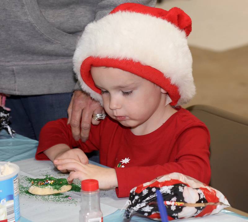 Four year old Finley Canady decorates a cookie at the Kendall County Historical Society’s Annual Christmas at the Lyon Farm on Sunday, Dec. 8, 2024 in Yorkville.