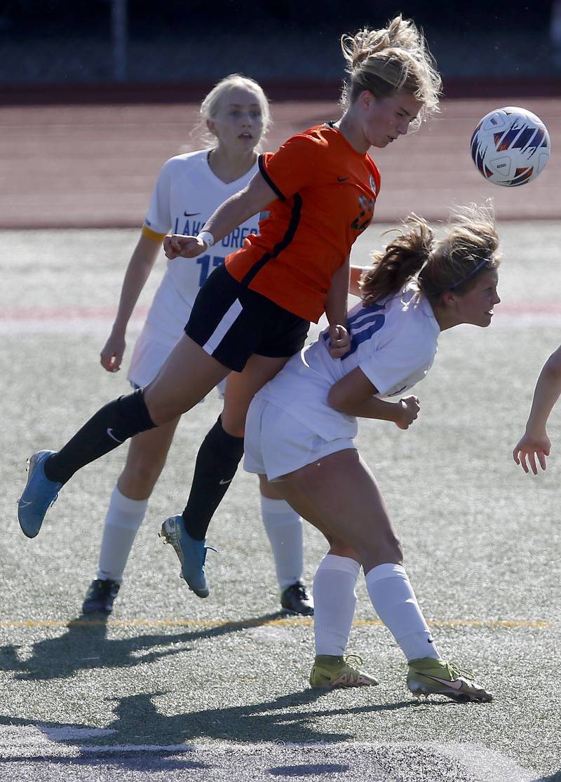 Crystal Lake Central's Olivia Anderson heads the ball over Lake Forest's Caroline Kaiser during a Class 2A Deerfield Sectional semi-final match on Tuesday, May 21, 2024, at Deerfield High School.