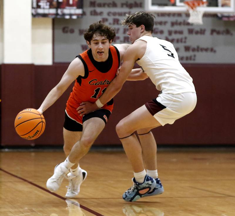 Crystal Lake Central's Johnny Geisser tries to drive against the defense of Prairie Ridge's Elijah Loeding during an IHSA Class 3A Prairie Ridge Regional basketball game on Monday, Feb. 24, 2025, at Prairie Ridge High School.