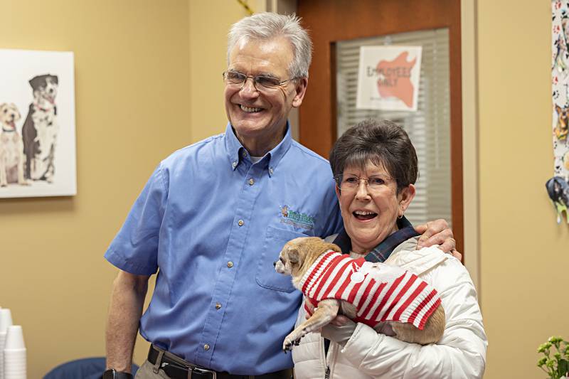 Dr. Bill Kuhfus poses for a photo with Rose Henry and Isabelle Thursday, Dec. 28, 2023 during an open house for the retiring veterinarian.