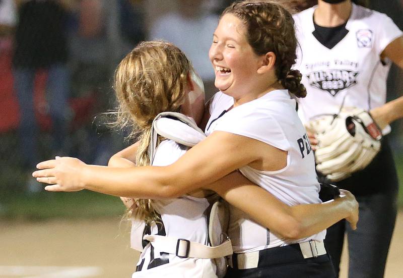 Spring Valley's Brynn Pellegrini hugs catcher Vivi Verucchi after winning the Minor League Softball State title on Thursday, July 27, 2023 at St. Mary's Park in La Salle.