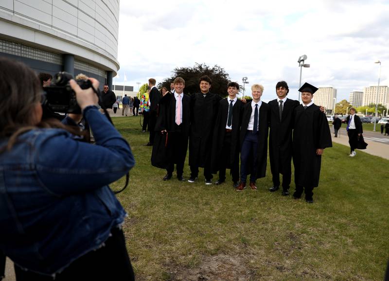 St. Charles East graduates pose for photos before the school’s 2025 commencement ceremony on Thursday, May 22, 2025 at Northern Illinois University in DeKalb.