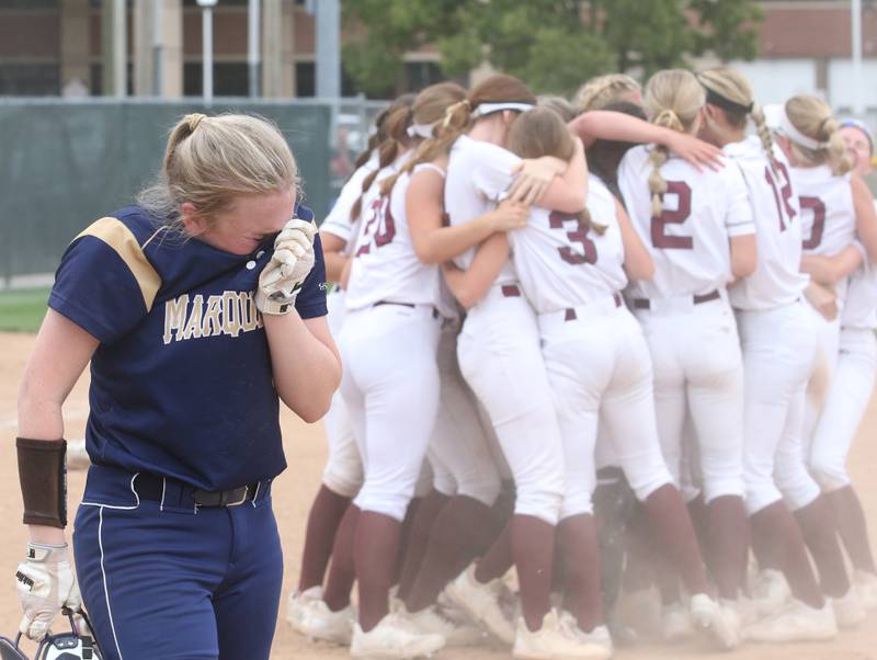 Marquette's Kaylee Killela reacts to her team's defeat as the LeRoy softball team celebrates winning the Class 1A Illinois Wesleyan Supersectional, outlasting Marquette 2-1 on Monday, May 29, 2023, in Bloomington.