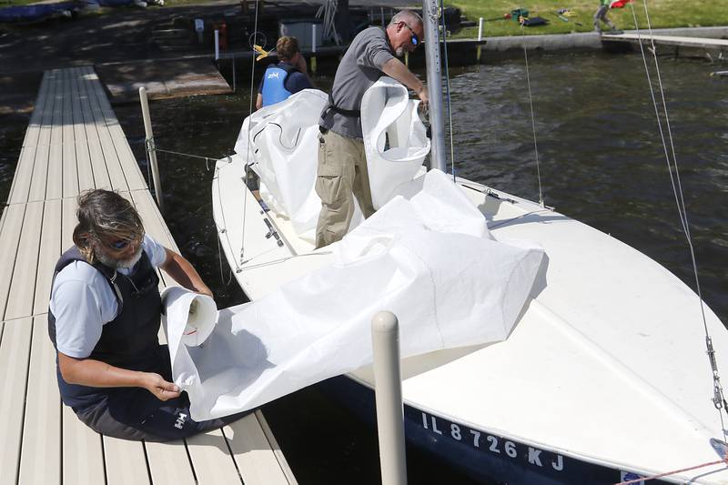 Steven Palmer rolls up a jib while preparing to sail during a US Sailing adaptive sailing class on Saturday, May 4, 2024, at the Pistakee Yacht Club's Community Sailing School in Johnsburg.