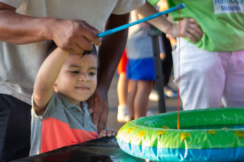 Wilmer Cuz plays a fishing game Friday, Aug. 23, 2024, at Family Safe Night outside of the Mendota Civic Center.