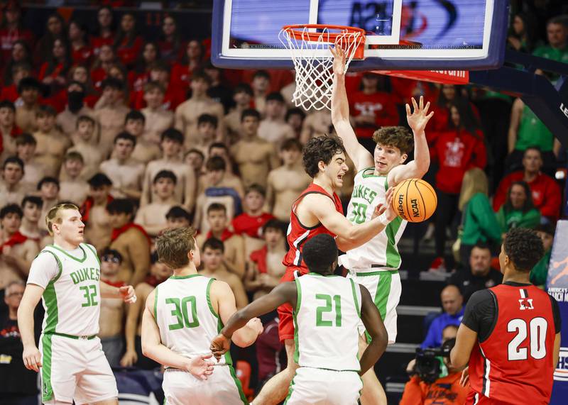 York’s Hunter Stepanich (50) gets in the path of Marist's Adoni Vassilakis (0) as he looks to pass to an open teammate during the IHSA Class 4A boys basketball state semifinal Friday, March 13, 2026 at the State Farm Center in Champaign.