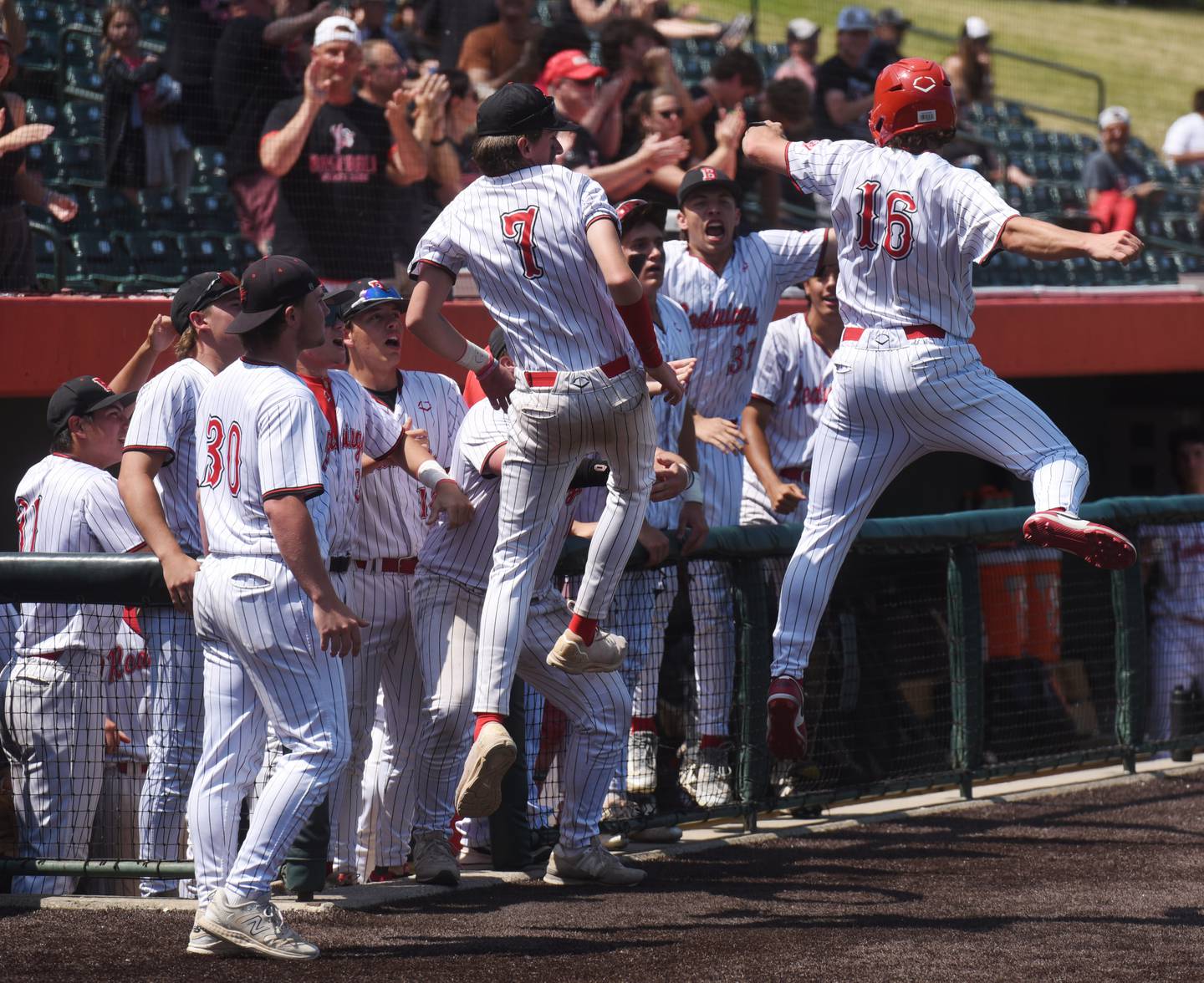 Benet Academy’s Merrick Sullivan, right, celebrates with teammate Benet Academy Jimmy Jasinski (7) after scoring during the bottom of the fifth inning in the Class 3A state baseball title game against St. Laurence at Slammers Stadium on Saturday, June 14, 2025 in Joliet.