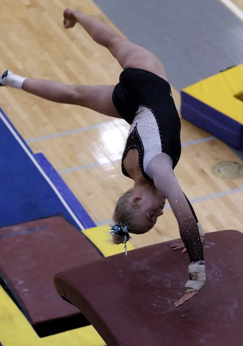 Lincolnway East's Flynn Meyer competes in the preliminary round of the vault on Friday, Feb. 21, 2025, during the IHSA Girls State Final Gymnastics Meet at Palatine High School.