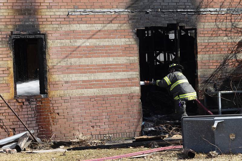 Dixon City firefighters work to extinguish hot spots in the afternoon on Monday, March 2, 2026, after previously fighting a fire in the 1100 block of West First Street. Dixon City responded to the fire at 2:21 a.m. and cleared the scene at 6:19 a.m.