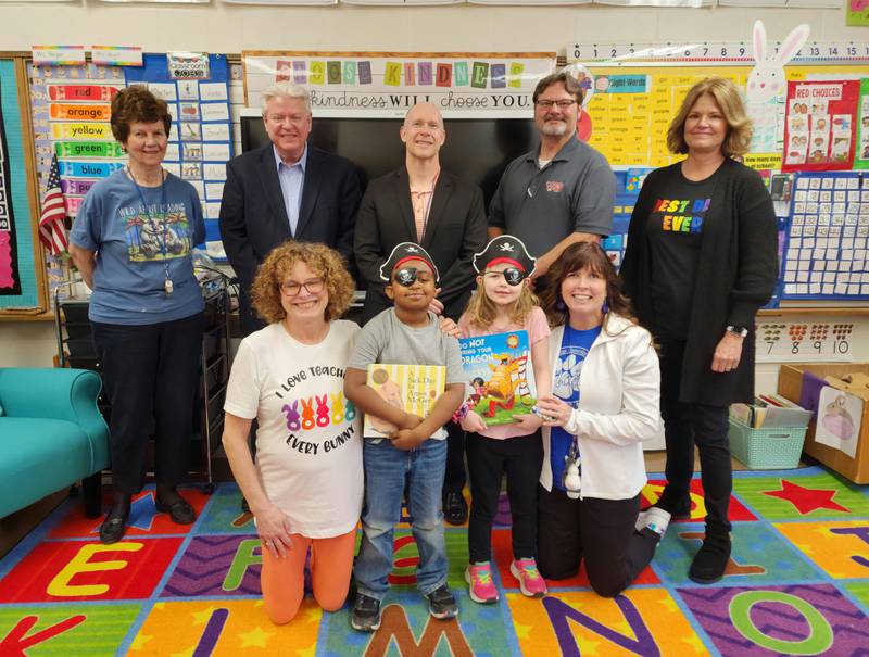 Librarian Eleanor Walker, PES Board President Steve Bouslog, Superintendent J.D. Orwig, Books Blast Rep. Rick Beals and Principal Lynette Bima pose with top-raising classroom teachers Stacey Harper and Holly Wright with top-earner Caroline Krug and Ipad winner Carter Butler.